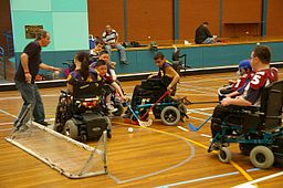 Children in electric wheelchairs playing power hockey
